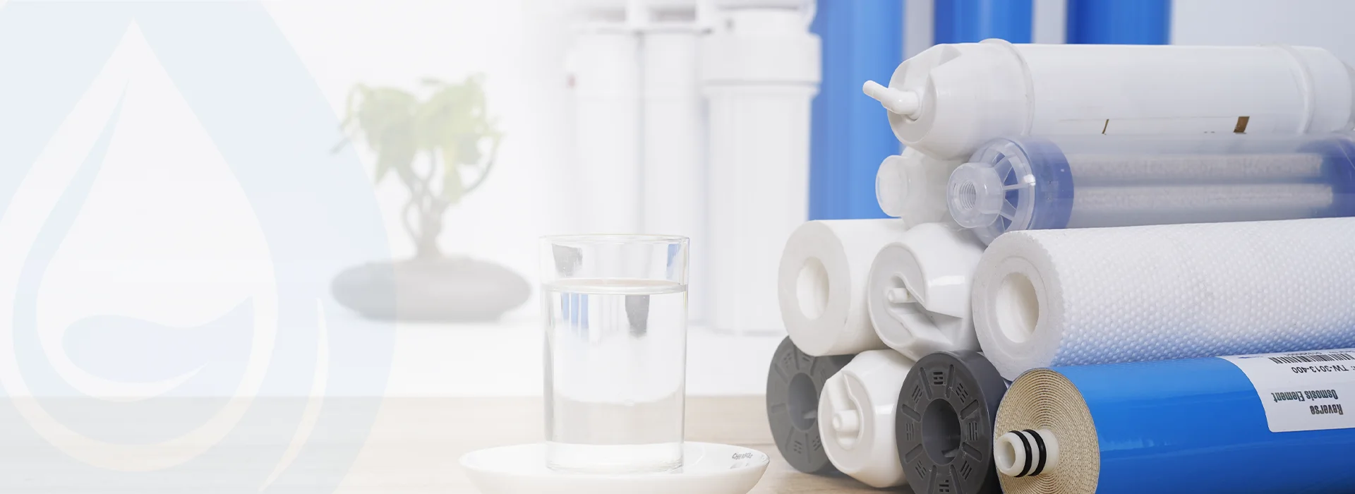 A cup of water and multiple filter cartridges are placed on the table.