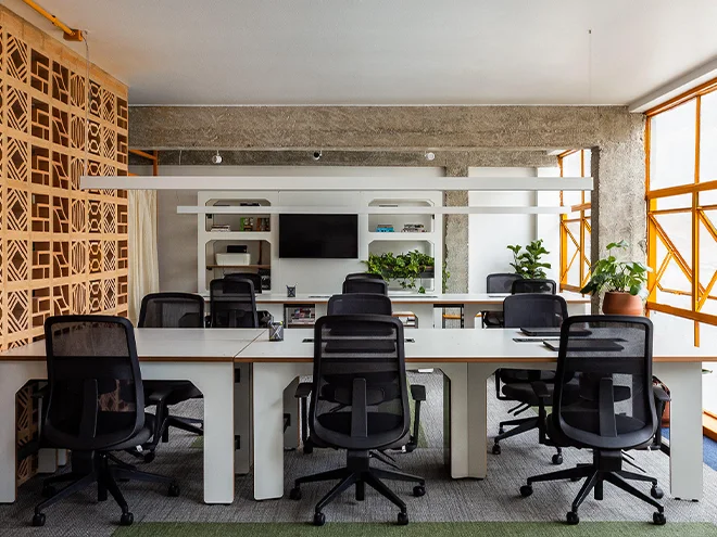Several office desks and chairs placed in an office