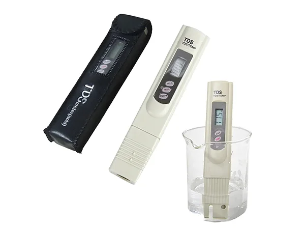 Two TDS meters, one white TDS meter inserted into water measuring TDS