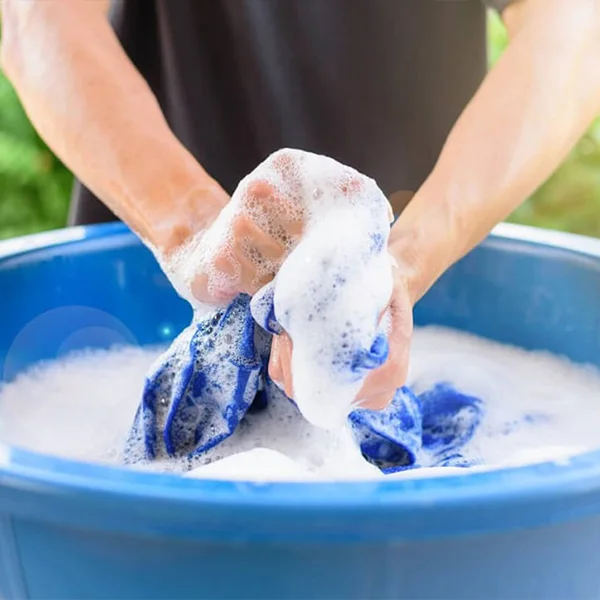 A person washing clothes in a basin